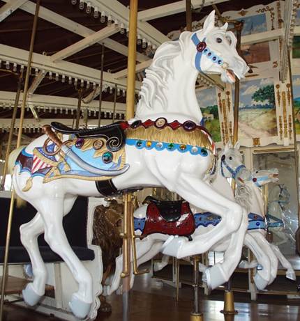 A white horse on a merry go round

Description automatically generated