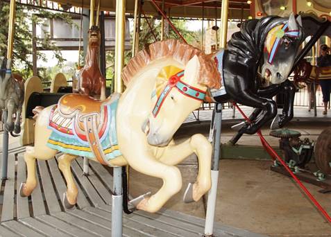A picture containing carousel, outdoor object, ride, floor

Description automatically generated