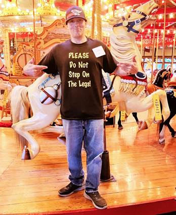 A person standing in front of a carousel
AI-generated content may be incorrect.