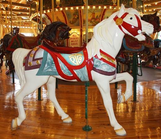 A horse statue in front of a carousel
Description generated with high confidence