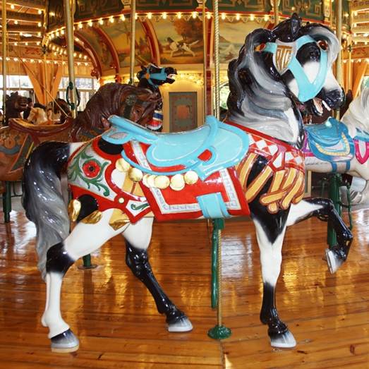 A person standing in front of a carousel
Description generated with high confidence