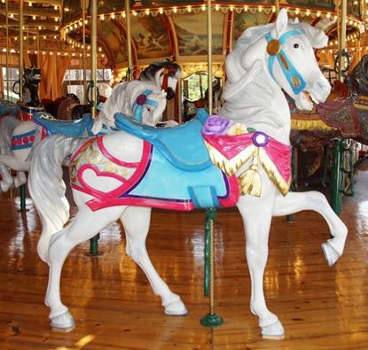 A horse standing on top of a carousel
Description generated with very high confidence