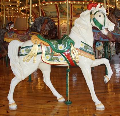 A picture containing carousel, ride, outdoor object, floor
Description generated with very high confidence
