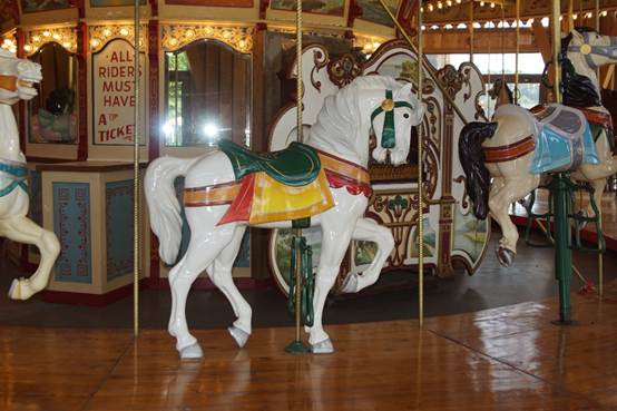 A white horse on a merry go round

Description automatically generated