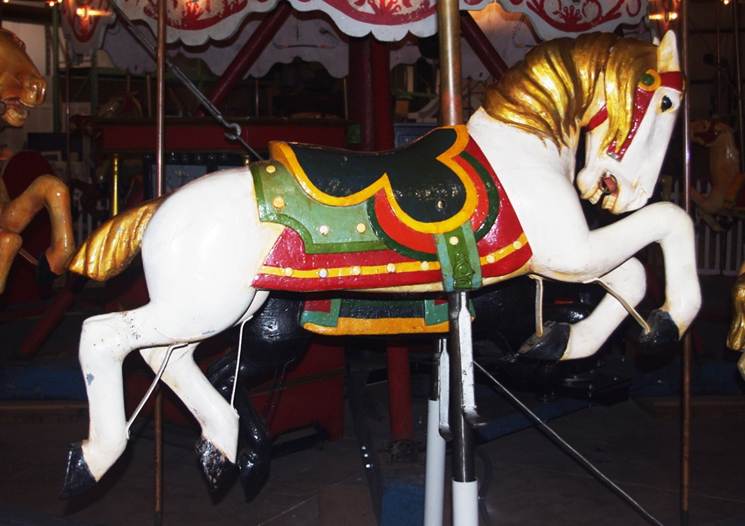 A picture containing floor, carousel, indoor, ride

Description automatically generated