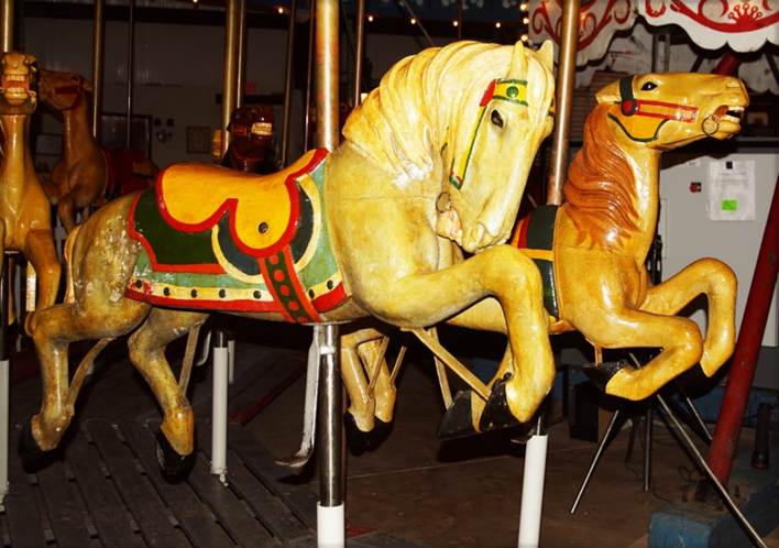 A picture containing text, indoor, carousel, ride

Description automatically generated