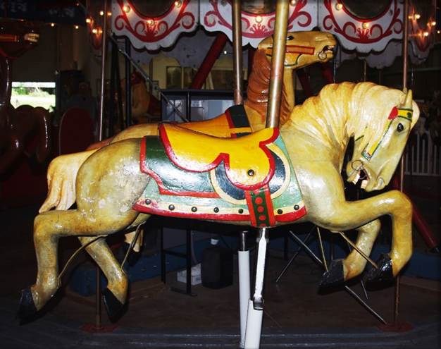 A picture containing carousel, outdoor object, ride, floor
Description automatically generated