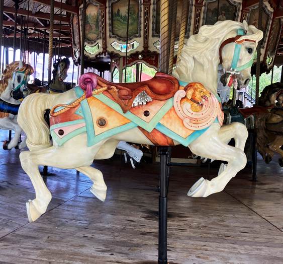 A carousel with horses on a wooden floor
AI-generated content may be incorrect.