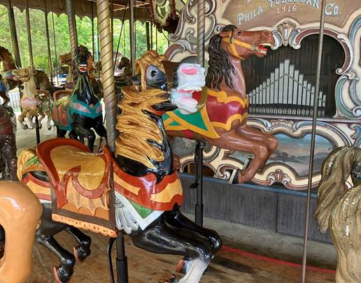 A carousel with horses on it

AI-generated content may be incorrect.