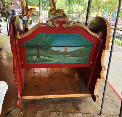 A wooden rocking chair with a painting on it

AI-generated content may be incorrect.
