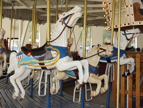A picture containing carousel, ride, outdoor object, floor

Description automatically generated