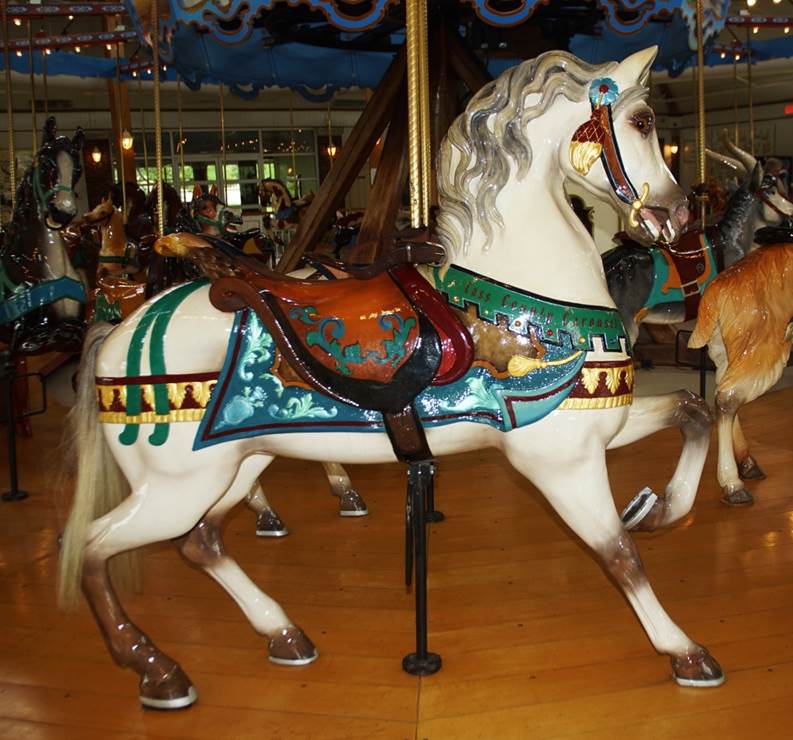 A carousel horse with a horse saddle
Description automatically generated