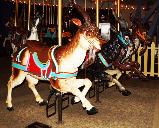 A group of animals on a merry go round
Description automatically generated
