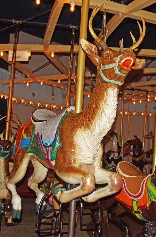 A reindeer on a merry go round
Description automatically generated