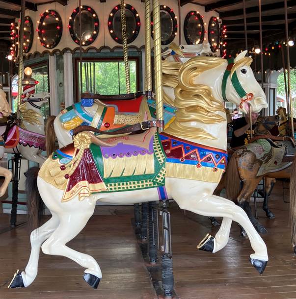 A carousel horse with colorful decorations

AI-generated content may be incorrect.