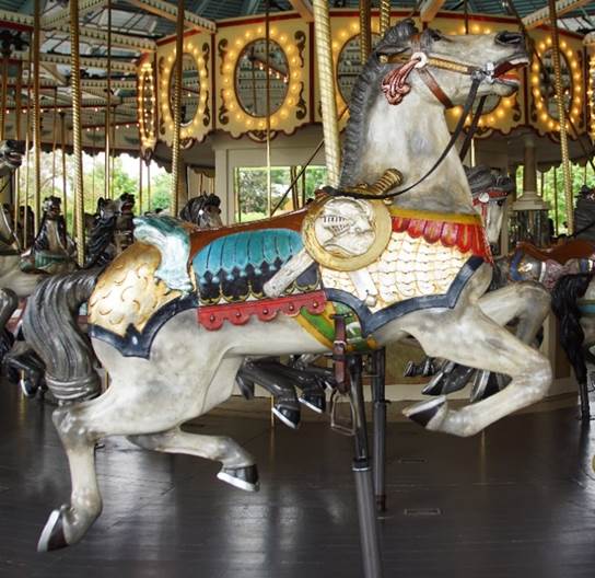 A group of people in a carousel

Description generated with high confidence