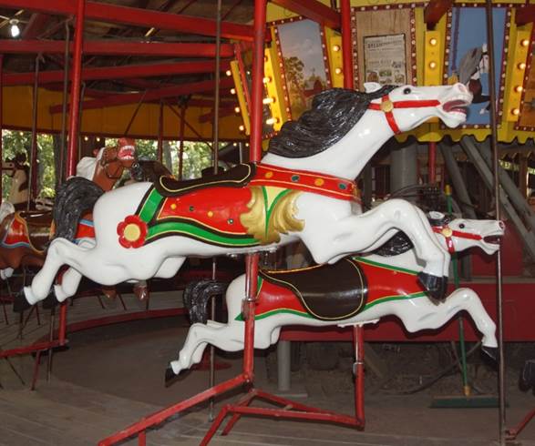 A large red chair in front of a carousel
Description generated with high confidence