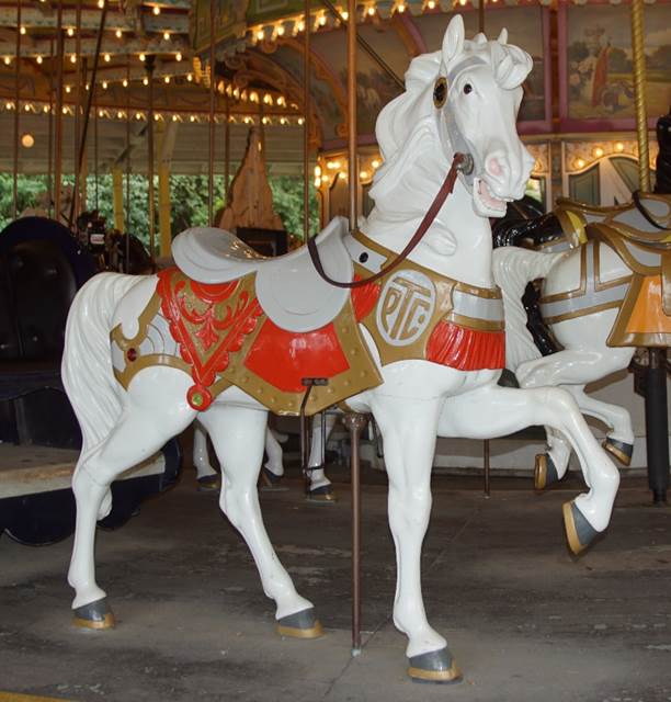 A horse statue in front of a carousel
Description generated with very high confidence