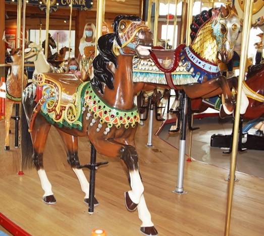 A picture containing floor, carousel, indoor, ride

Description automatically generated