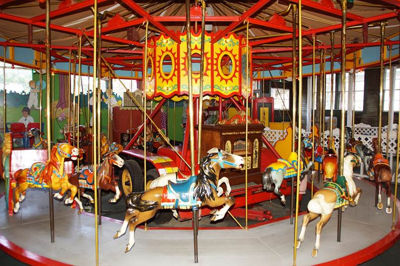 A picture containing carousel, outdoor object, ride, colorful
Description automatically generated