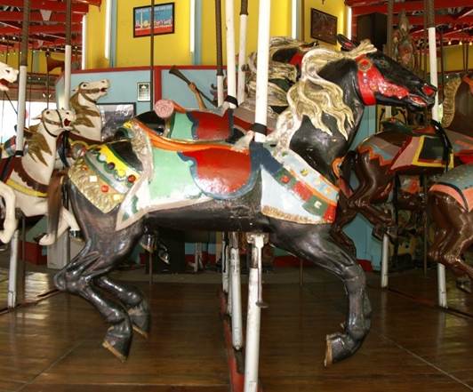 A carousel horse with horses on it

Description automatically generated