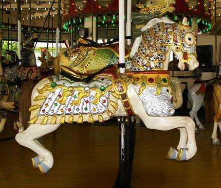 A carousel horse with gold and white decorations
Description automatically generated