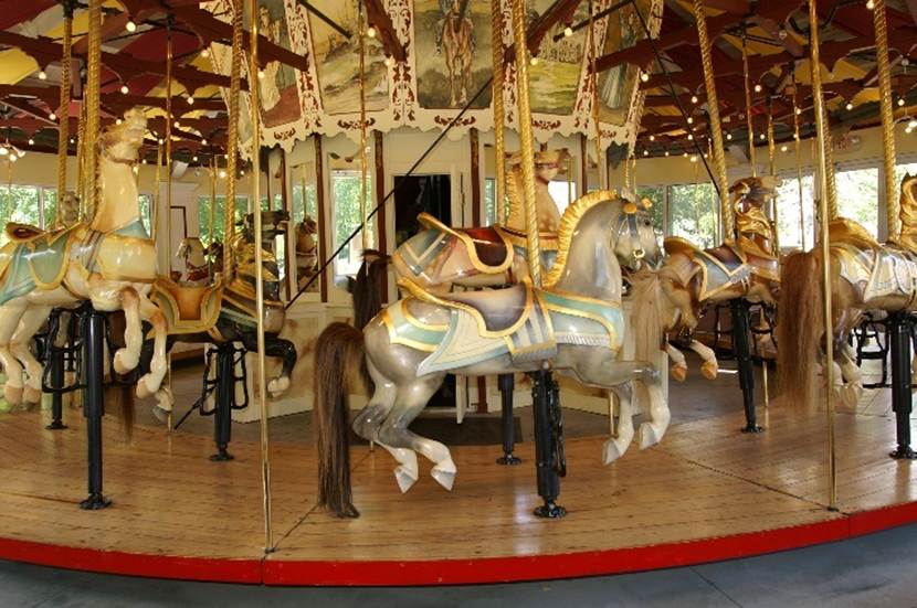 A merry go round with horses
Description automatically generated