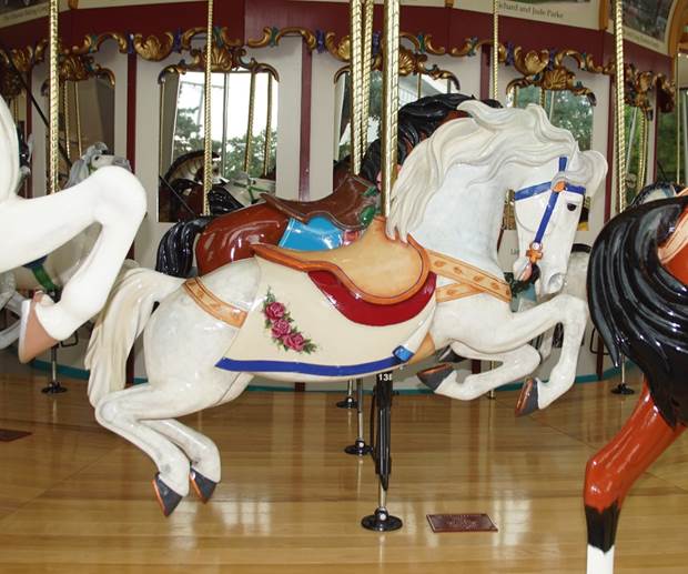 A carousel horse with saddles

Description automatically generated