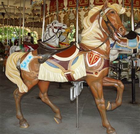 A person riding a horse in a carousel

Description automatically generated