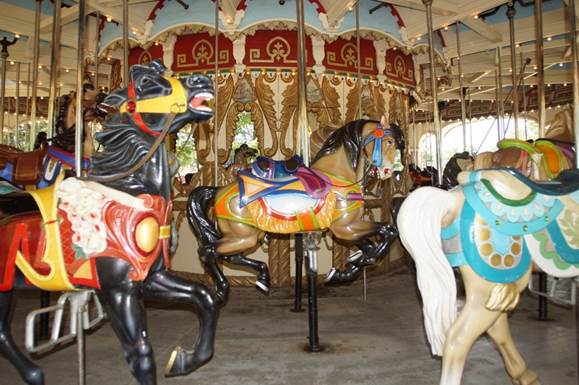 A group of people in a carousel

Description automatically generated