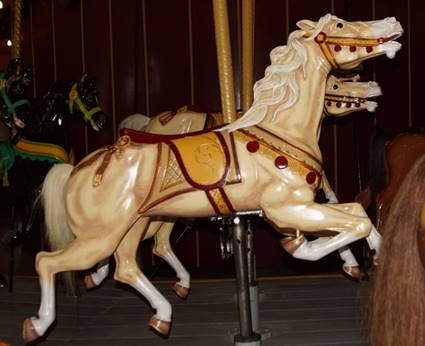 A picture containing carousel, ride, horse, amusement ride

Description automatically generated