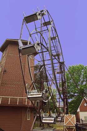 A ferris wheel in front of a building

Description automatically generated with low confidence