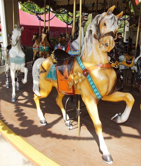A merry go round with horses

Description automatically generated