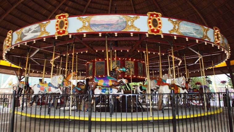 A merry go round with horses
Description automatically generated