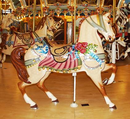 A picture containing carousel, ride, floor, outdoor object

Description automatically generated