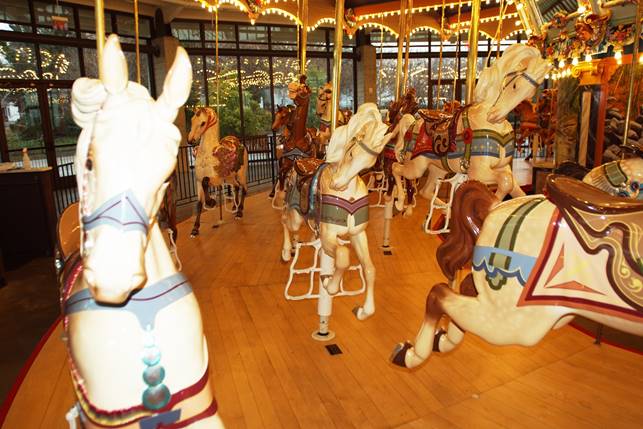 A picture containing indoor, floor, carousel, ride

Description automatically generated