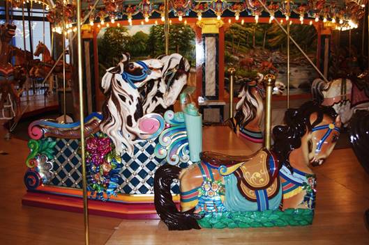 A picture containing carousel, ride, outdoor object, decorated

Description automatically generated