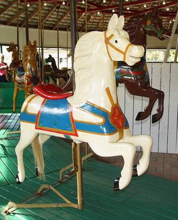 A chair sitting in front of a carousel

Description generated with high confidence