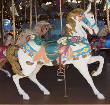 A person riding a horse in a carousel
Description generated with high confidence