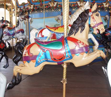A person standing in front of a carousel
Description generated with high confidence