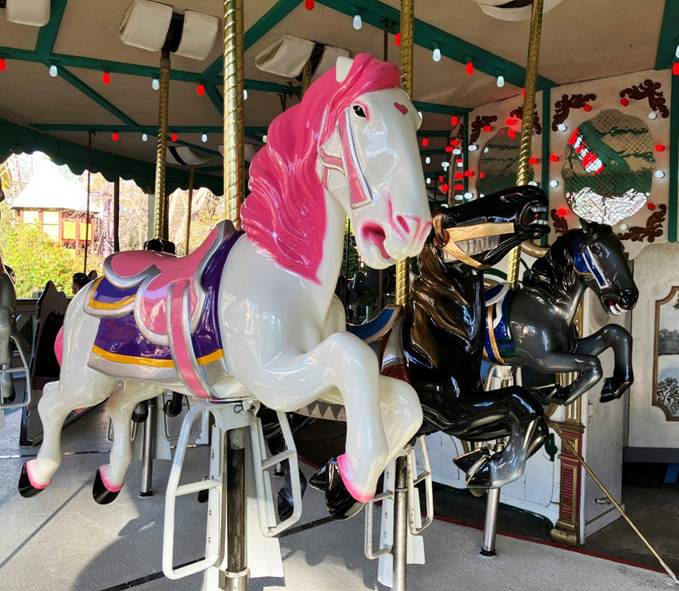 A group of horses on a merry go round

AI-generated content may be incorrect.