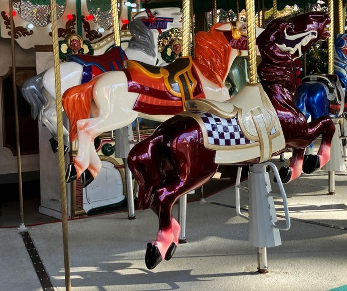 A group of horses on a merry go round

AI-generated content may be incorrect.