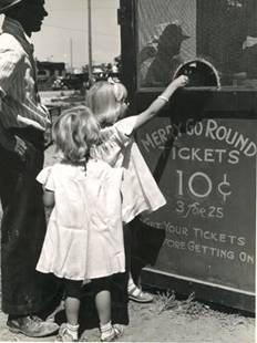 A group of people standing in front of a sign
Description automatically generated