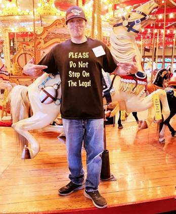 A person standing in front of a carousel
AI-generated content may be incorrect.