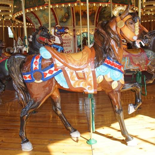 A person riding a horse in a carousel

Description generated with very high confidence