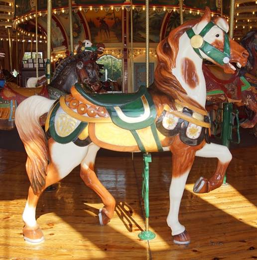 A person riding a horse in a carousel
Description generated with high confidence
