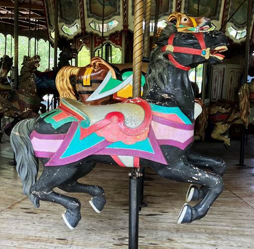 A carousel with horses on it
AI-generated content may be incorrect.