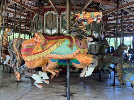 A carousel with horses on a pole
AI-generated content may be incorrect.