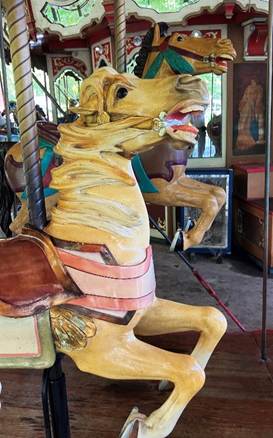 A carousel horse with a horse on it
AI-generated content may be incorrect.