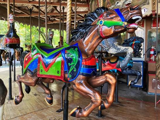 A carousel with horses on it
AI-generated content may be incorrect.
